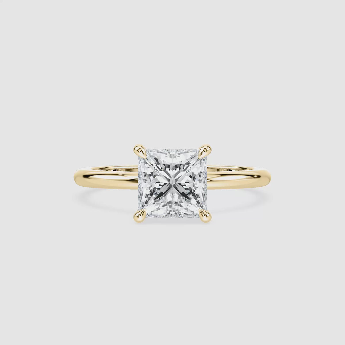 Video laden: Clara Solitaire Verlobungsring – Prinzessschliff – Gelbgold – Video